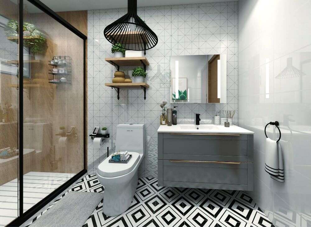 Se observa un baño moderno con una atractiva combinación de colores gris, blanco y negro. El piso geométrico, las repisas flotantes y la mampara de cristal añaden personalidad y un estilo contemporáneo al espacio.