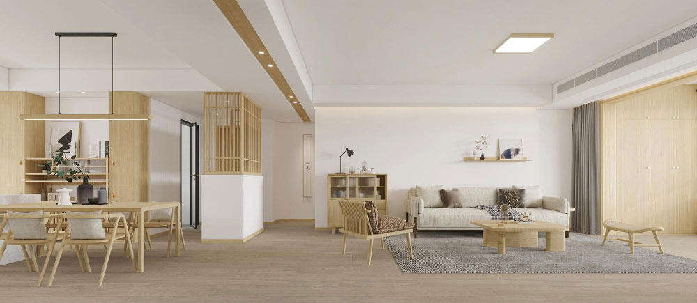 La fotografía presenta un espacio abierto con comedor y sala en estilo minimalista japonés. Los acabados en madera clara, tonos neutros y mobiliario de líneas simples crean un ambiente elegante, amplio y lleno de serenidad.