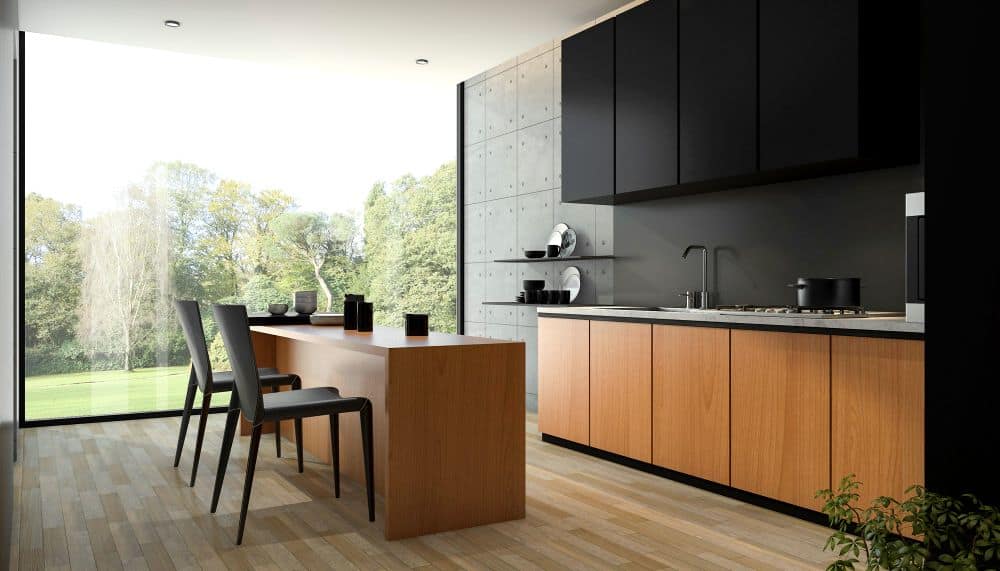 Cocina de estilo minimalista con una gran isla-comedor de madera. Los gabinetes negros y los acabados de concreto generan una estética moderna e industrial con vistas al exterior.