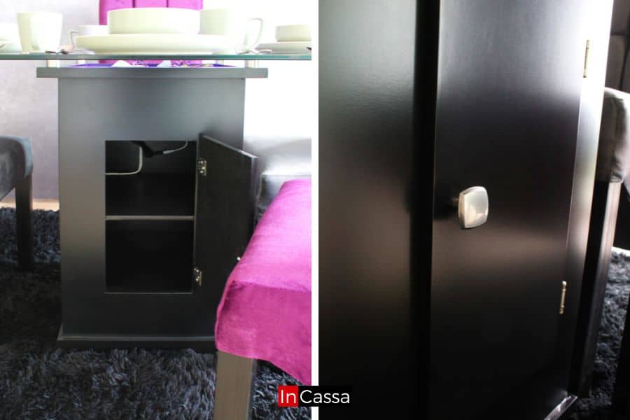 Un conjunto de dos fotos diferentes, en las que se resalta el pedestal de la mesa a partir de varios ángulos. El pedestal es de color chocolate y cuenta con una puerta con jaladera metálica cuadrada, en su interior se encuentra un espacio dividido en dos compartimentos por un entrepaño, los cuales conservan el acabado chocolate.