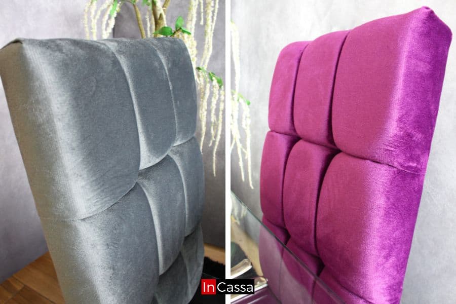 La imagen muestra los respaldos de 2 de las 4 sillas del comedor, presentado del lado izquierdo una silla en tapiz suede gris perla, mientras que del lado derecho se puede apreciar una silla tapizada en suede morado; ambas con acabado capitoneado.