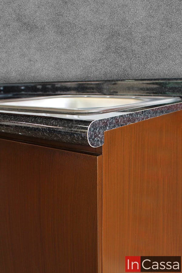 El borde redondeado de la cubierta de formaica en estilo mármol negro proporciona una terminación suave y sofisticada, además de ser fácil de limpiar y mantener en excelentes condiciones.