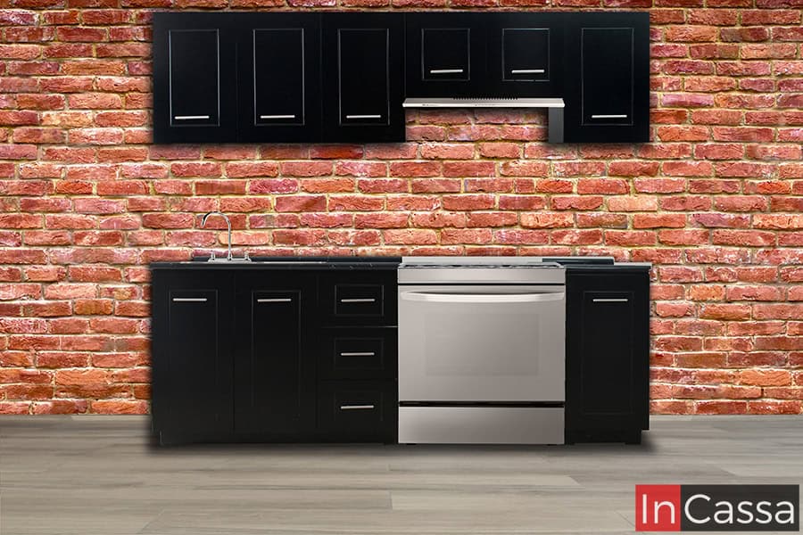 Cocina integral con un diseño contemporáneo con gabinetes en acabado negro mate, cubierta de formaica, y tiradores metálicos. Incluye módulo superior con espacio para campana, optimizando el espacio. Ideal para estilos industriales y modernos.