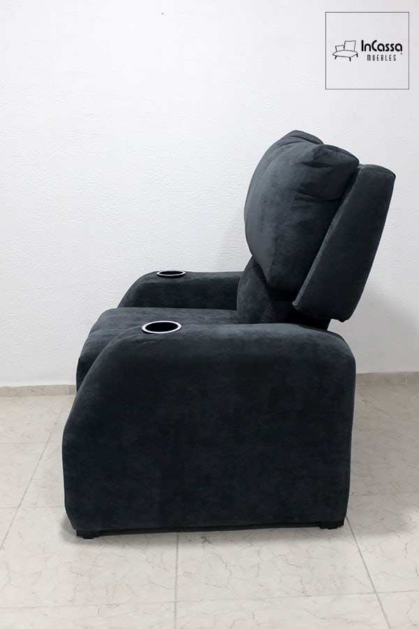 Se nos presenta el sillón desde una toma lateral con su respaldo en una posición vertical, en la que también podemos apreciar completamente su estructura tapizada en suede gris oxford, además del acolchonado de su asiento y respaldo.