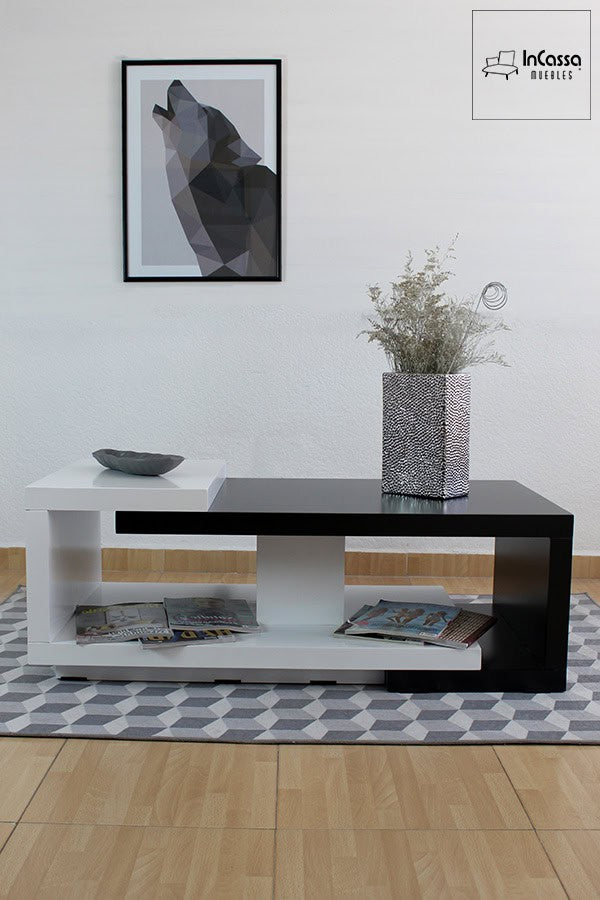 Esta fotografía presenta la mesa de centro modelo ISLANDIA en acabado blanco y negro brillante. Su estructura geométrica con entrepaño inferior la convierte en una pieza funcional y moderna ideal para salas contemporáneas.