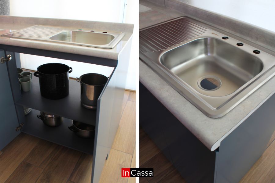 En estos detalles se aprecia la tarja de acero inoxidable integrada a la cubierta tipo ojo de pájaro, junto con el módulo inferior en gris oxford. Sus repisas amplias permiten organizar utensilios con practicidad en un diseño moderno.