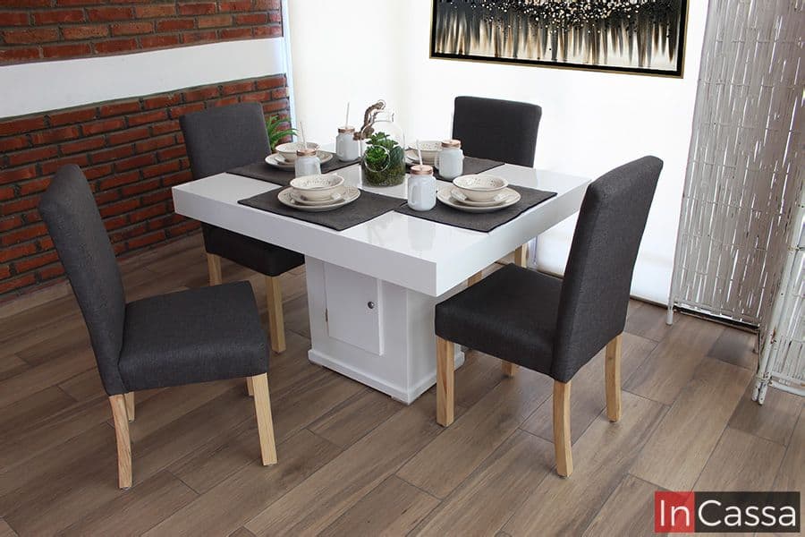 En esta foto, se presenta un comedor compacto y moderno que combina una mesa blanca de acabado brillante con cuatro sillas tapizadas en lino mouse. La mesa cuenta con una base central que incluye un compartimento de almacenamiento, ideal para mantener el área organizada. Este conjunto es perfecto para espacios reducidos, aportando un toque de estilo contemporáneo y funcionalidad.