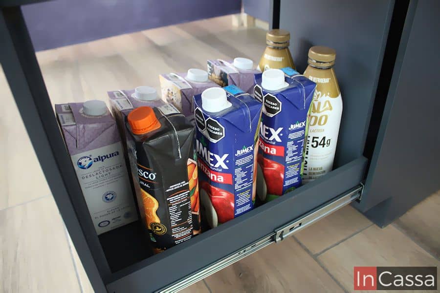 Una toma superior del compartimento inferior del despensero, el cuál almacena jugos y leche embotellados. Exhibido en un elegante acabado gris oxford completo, el despensero cuenta con un práctico diseño extraíble para almacenar todo tipo de alimentos y especias de manera eficiente.