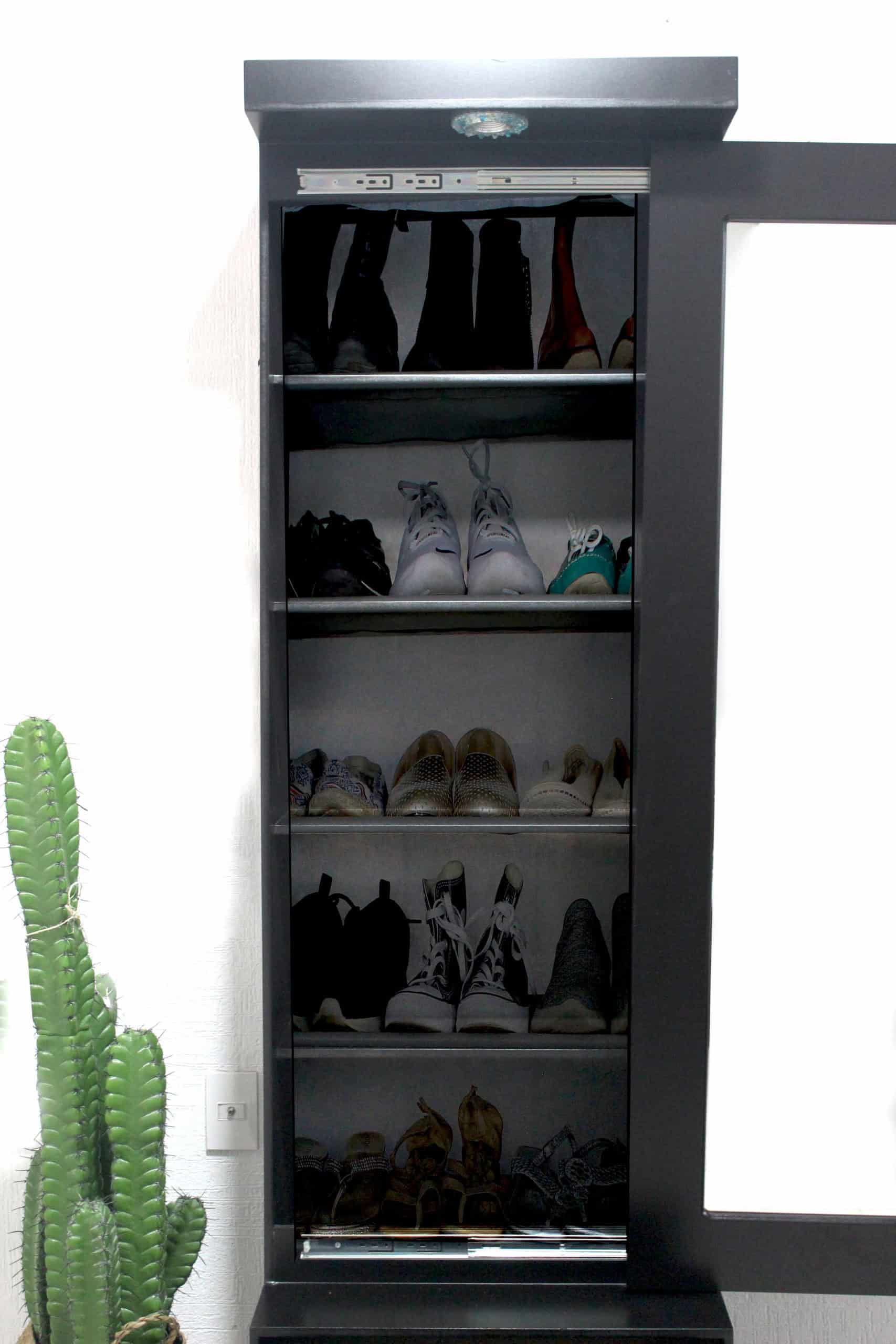 La imagen revela el interior del espejo vestidor Queens en acabado chocolate completo, equipado con repisas que organizan hasta cinco niveles de calzado. Cada espacio es ideal para mantener ordenados desde tenis hasta botas, aprovechando al máximo su diseño vertical.