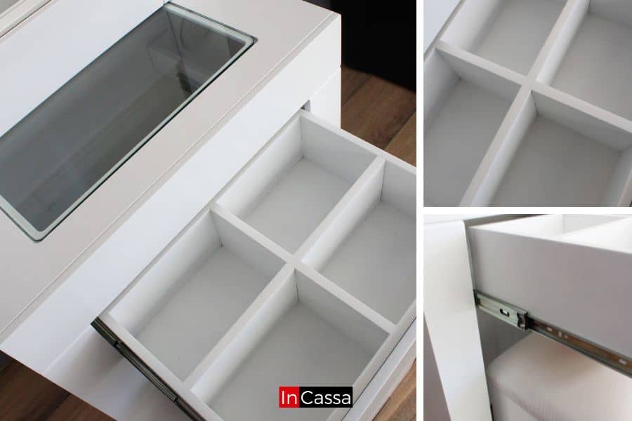 Una fotografía cercana destaca el cajón con divisiones internas del tocador blanco Santorini. Se observa su cubierta de cristal y correderas metálicas, ideales para mantener maquillaje y accesorios perfectamente ordenados.
