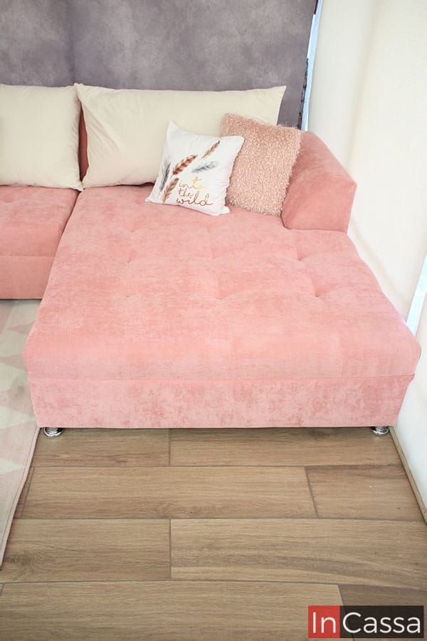 Podemos observar el chaise long derecho (viendo la sala de frente), resaltando el acabado rosa de la tela suede, el chaise long esta acompañado de un gran cojín ancho tapizado en suede hueso junto con otros dos decorativos de menor tamaño (no incluidos en el precio)