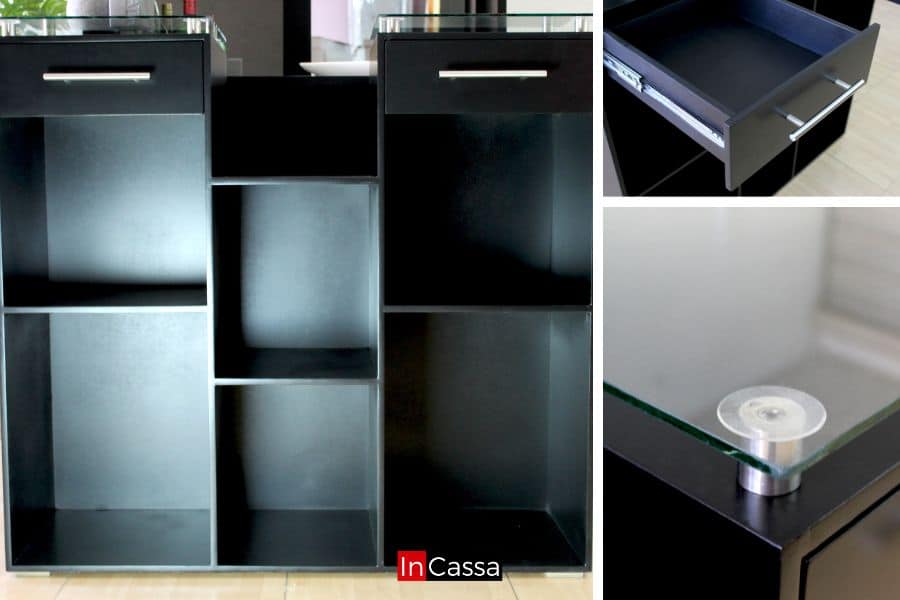 La imagen principal muestra una vista frontal de la barra modelo TUCSON en acabado chocolate mate, con seis compartimentos abiertos de diferentes alturas para almacenamiento funcional. En la parte superior se observan dos cajones con correderas metálicas y jaladeras tubulares de acero inoxidable. A la derecha, dos acercamientos detallan el interior del cajón y los soportes circulares de metal que sostienen la cubierta de cristal templado.