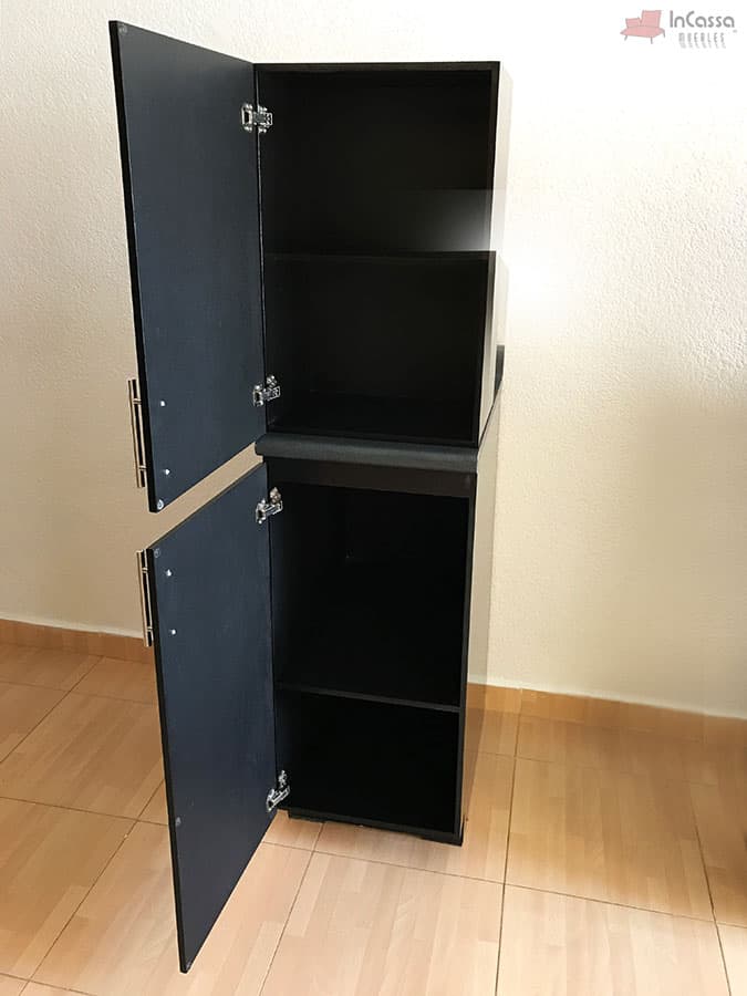 Una toma del módulo superior e inferior lateral de la Cocina Integral Irlanda para Estufa en color negro brillante, con puertas abiertas que revelan repisas internas superiores e inferiores. Su diseño vertical ofrece gran capacidad de almacenamiento, complementado con tiradores metálicos modernos y cubierta estilo mármol negro que aporta un acabado elegante y sofisticado.