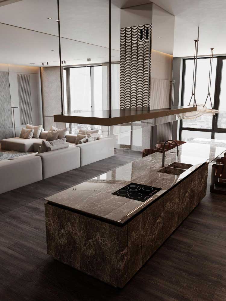 Una fotografía en ángulo abierto revela una lujosa cocina integrada a la sala, donde destaca una isla de mármol marrón con vetas naturales y acabado brillante. La superficie incluye una moderna parrilla de inducción y un fregadero con cubierta deslizante. El diseño abierto, el suelo oscuro y el mobiliario claro crean un contraste elegante que resalta la sofisticación del espacio.